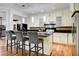 Charming kitchen with light cabinets, granite counters, stainless appliances, and bar seating at 2508 Monarch Bay Dr, Las Vegas, NV 89128