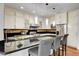 Bright kitchen featuring stainless appliances, granite counters, and a stylish breakfast bar at 2508 Monarch Bay Dr, Las Vegas, NV 89128