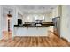 Well-lit kitchen with stainless steel appliances, ample counter space, and an adjacent dining area at 2508 Monarch Bay Dr, Las Vegas, NV 89128