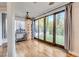 Bright sunroom boasts large sliding doors, backyard views, and beautiful hardwood floors at 2508 Monarch Bay Dr, Las Vegas, NV 89128