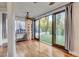 Bright sunroom boasts large sliding doors, backyard views, and beautiful hardwood floors at 2508 Monarch Bay Dr, Las Vegas, NV 89128