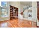 Bright living room with hardwood floors and large built-in bookcase with ladder feature at 2508 Monarch Bay Dr, Las Vegas, NV 89128