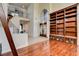 Spacious living room with hardwood floors, built-in shelving, and a staircase to the upper level at 2508 Monarch Bay Dr, Las Vegas, NV 89128