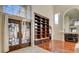 Open floor plan living room with hardwood floors, built-in shelving, and an ornate fireplace at 2508 Monarch Bay Dr, Las Vegas, NV 89128