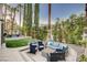 Inviting outdoor patio area with modern furniture, lush landscaping, and pool at 2508 Monarch Bay Dr, Las Vegas, NV 89128