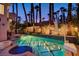Backyard pool with decorative tiling, hot tub, basketball hoop, and perimeter string lights at 2508 Monarch Bay Dr, Las Vegas, NV 89128