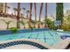 Backyard pool featuring mature landscaping, desert trees, and blue tile at 2508 Monarch Bay Dr, Las Vegas, NV 89128