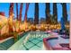 Backyard pool featuring a spa, lounge chairs, and string lights at 2508 Monarch Bay Dr, Las Vegas, NV 89128