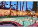 Backyard pool featuring a spa, basketball hoop, and string lights at 2508 Monarch Bay Dr, Las Vegas, NV 89128