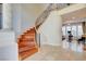 Beautiful curved staircase with wood treads and wrought iron spindles open to exercise room at 2508 Monarch Bay Dr, Las Vegas, NV 89128