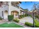 Spacious backyard featuring a covered patio, upper balcony, manicured shrubs, and exterior lighting at 2737 Josephine Dr, Henderson, NV 89044