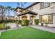 Expansive backyard with manicured landscaping, covered patio, and elegant architectural details at 2737 Josephine Dr, Henderson, NV 89044
