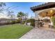 Serene backyard featuring a covered patio, lush lawn, decorative landscaping, and unobstructed views at 2737 Josephine Dr, Henderson, NV 89044