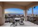 Covered balcony with wrought iron railing and seating offers views of the surrounding mountains and community at 2737 Josephine Dr, Henderson, NV 89044