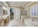 Elegant bathroom boasts double sinks, a glass-enclosed shower, and a luxurious soaking tub for ultimate relaxation at 2737 Josephine Dr, Henderson, NV 89044