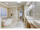 Upscale bathroom featuring double sinks, a soaking tub, a walk-in shower, and stylish tile accents throughout at 2737 Josephine Dr, Henderson, NV 89044