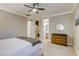 Neutral bedroom features a ceiling fan, carpet flooring, and a classic wood dresser at 2737 Josephine Dr, Henderson, NV 89044
