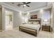 Bedroom with carpet, ceiling fan, and plantation shutters, adjacent to an ensuite bathroom at 2737 Josephine Dr, Henderson, NV 89044