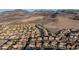 An aerial view of a community surrounded by desert mountains showcases residential homes and landscape planning at 2737 Josephine Dr, Henderson, NV 89044