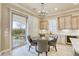 Cozy dining area with a round table, chandelier, and sliding glass doors leading to an outdoor patio at 2737 Josephine Dr, Henderson, NV 89044