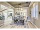 Formal dining room with a modern chandelier, neutral color palette, and views into the entryway and living room at 2737 Josephine Dr, Henderson, NV 89044