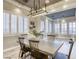 Elegant dining room boasts a modern chandelier, plantation shutters, and views of the entryway and living room at 2737 Josephine Dr, Henderson, NV 89044