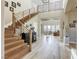 Bright entryway with wood staircase, modern railing, and open floor plan leads to the living room at 2737 Josephine Dr, Henderson, NV 89044