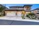 Elegant two-story home with a stone facade, well-manicured landscaping, and a convenient three-car garage at 2737 Josephine Dr, Henderson, NV 89044