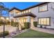 Elegant backyard with a covered patio, stone pillars, and lush landscaping, perfect for outdoor entertaining at 2737 Josephine Dr, Henderson, NV 89044