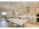 Open kitchen with center island, stainless appliances, custom cabinets, and a view to the outdoor patio at 2737 Josephine Dr, Henderson, NV 89044