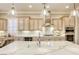 Kitchen island featuring a marble countertop, pendant lighting, modern appliances, and custom cabinets at 2737 Josephine Dr, Henderson, NV 89044