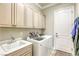 Well-organized laundry room with ample cabinetry, a sink, and modern washer and dryer units for convenience at 2737 Josephine Dr, Henderson, NV 89044