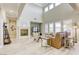 Spacious living room featuring a fireplace, large windows with plantation shutters, and wood-look flooring at 2737 Josephine Dr, Henderson, NV 89044