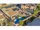 Expansive backyard featuring a pool, lounge area, manicured turf, mature landscaping, and solar panels at 2809 Proust Ct, Henderson, NV 89044