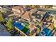 Beautiful aerial view of the backyard pool, patio, lounge area, and solar panels on the roof at 2809 Proust Ct, Henderson, NV 89044