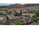 Aerial view of a home surrounded by desert landscaping, pools, and mountain views at 2809 Proust Ct, Henderson, NV 89044