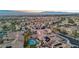Expansive aerial view of a neighborhood showcasing homes with tile roofs, solar panels, swimming pools and mountain views at 2809 Proust Ct, Henderson, NV 89044