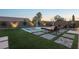 Lush backyard with a sparkling pool, elegant lounge furniture, and ambient lighting for evening enjoyment at 2809 Proust Ct, Henderson, NV 89044