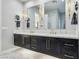 Bathroom featuring a double sink vanity, modern lighting, and a glass-enclosed shower with marble-style walls at 2809 Proust Ct, Henderson, NV 89044
