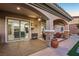 Stylish covered patio offers outdoor seating, ceiling fan, and access to the kitchen through sliding glass doors at 2809 Proust Ct, Henderson, NV 89044