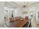 Open-concept dining room with modern light fixture and dark wood table at 2809 Proust Ct, Henderson, NV 89044