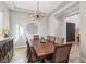 Dining room featuring a modern light fixture, a large wooden table with chairs and contemporary wall decor at 2809 Proust Ct, Henderson, NV 89044