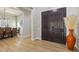 Inviting entryway with decorative vase, dark wood double doors, and view of the dining area with modern light fixture at 2809 Proust Ct, Henderson, NV 89044