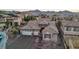 Aerial view of home with three car garage, tile roof, neutral stucco, and desert landscaping at dusk at 2809 Proust Ct, Henderson, NV 89044