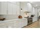 Bright kitchen featuring white cabinets, marble countertops, subway tile backsplash, and stainless steel appliances at 2809 Proust Ct, Henderson, NV 89044