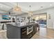 Open-concept kitchen features a large island, stainless steel appliances, and access to the backyard at 2809 Proust Ct, Henderson, NV 89044