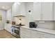 Kitchen features white cabinets, subway tile backsplash, stainless steel appliances, and modern countertops at 2809 Proust Ct, Henderson, NV 89044