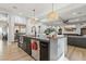 Kitchen boasts a large island with sink, stainless steel appliances, and flows into the living area at 2809 Proust Ct, Henderson, NV 89044