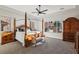 Bedroom features a four-poster bed, ceiling fan, carpet, windows with a view, and matching furniture at 2809 Proust Ct, Henderson, NV 89044