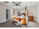 Bedroom features a four-poster bed, ceiling fan, carpet, and windows that look out onto the exterior at 2809 Proust Ct, Henderson, NV 89044
